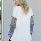 Heimish Full Size Animal Print Ruffle Trim Top -